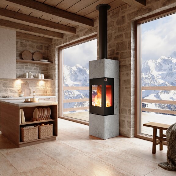 Holz Kaminofen NEXO 160 Speckstein in der Farbe Schwarz im Wohnraum mit Bergen 