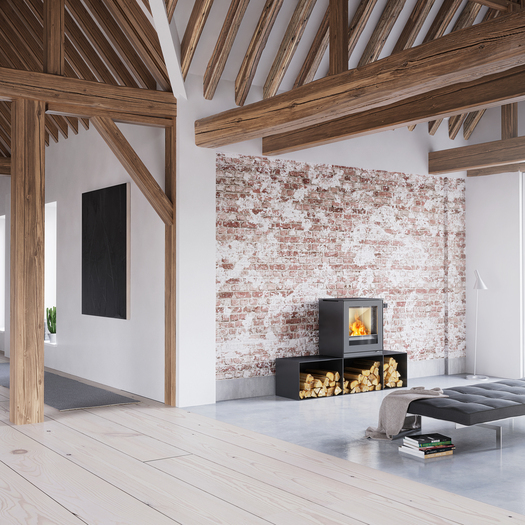 Poêle à bois Q-TEE 2 en noir avec des bancs dans une maison rustique meublée de façon minimaliste